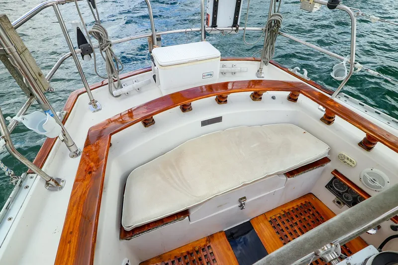 Slide: The Image of Cockpit of 1985 Bayfield 40 yacht with wooden trim and cushioned seating. - 10