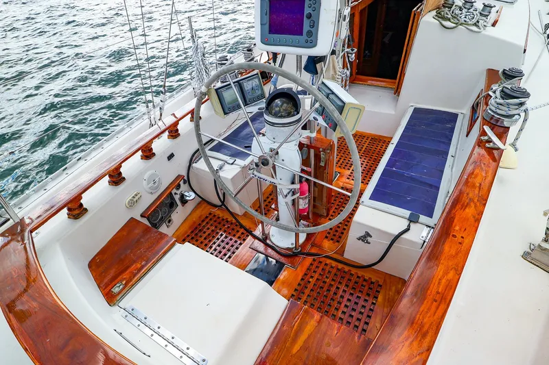 Slide: The Image of Cockpit of 1985 Bayfield 40 yacht with wooden accents and navigation equipment. - 11