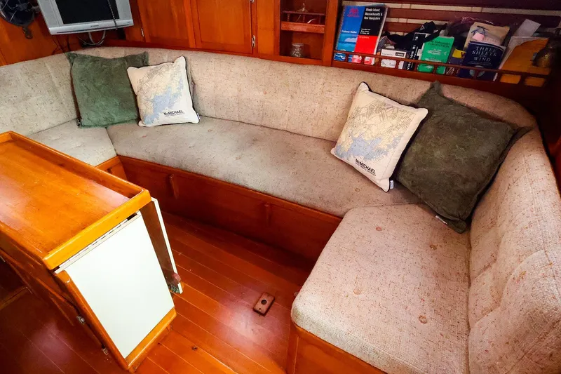 Slide: The Image of Cozy interior of 1985 Bayfield 40 yacht with cushioned seating and wooden accents. - 15