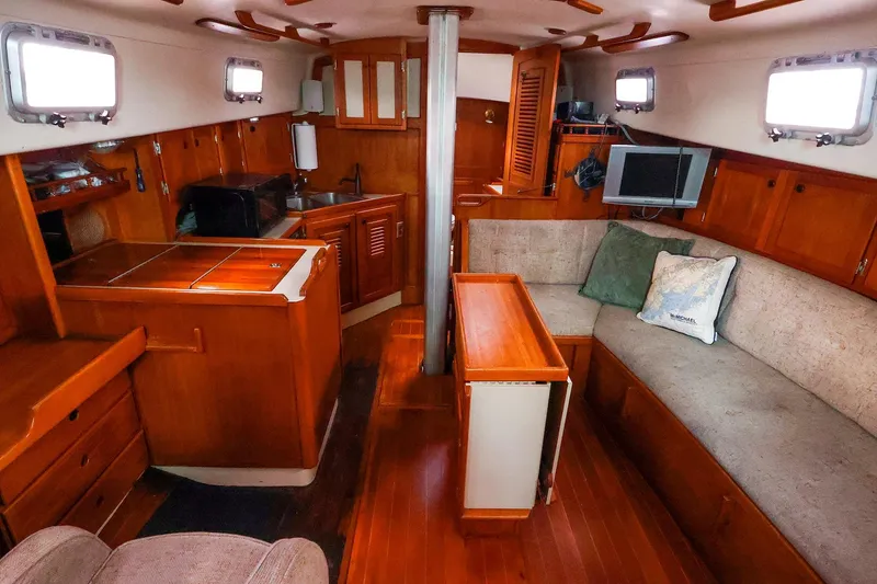 Slide: The Image of Interior of 1985 Bayfield 40 yacht with cozy seating and wooden cabinetry. - 16