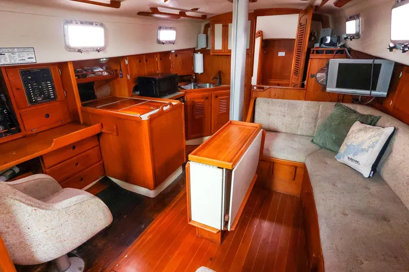 Slide: The Image of Interior of 1985 Bayfield 40 yacht with cozy seating and wooden cabinetry. - 17