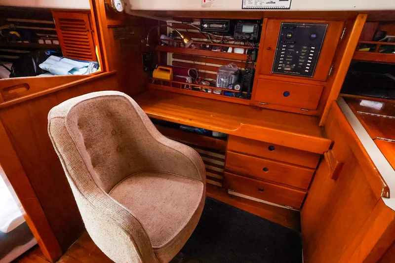 Slide: The Image of 1985 Bayfield 40 yacht interior with navigation station and comfortable chair. - 22