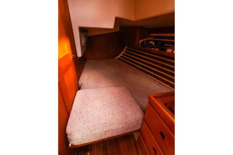Slide: The Image of Cozy cabin interior of 1985 Bayfield 40 yacht with wooden accents and cushioned berth. - 23