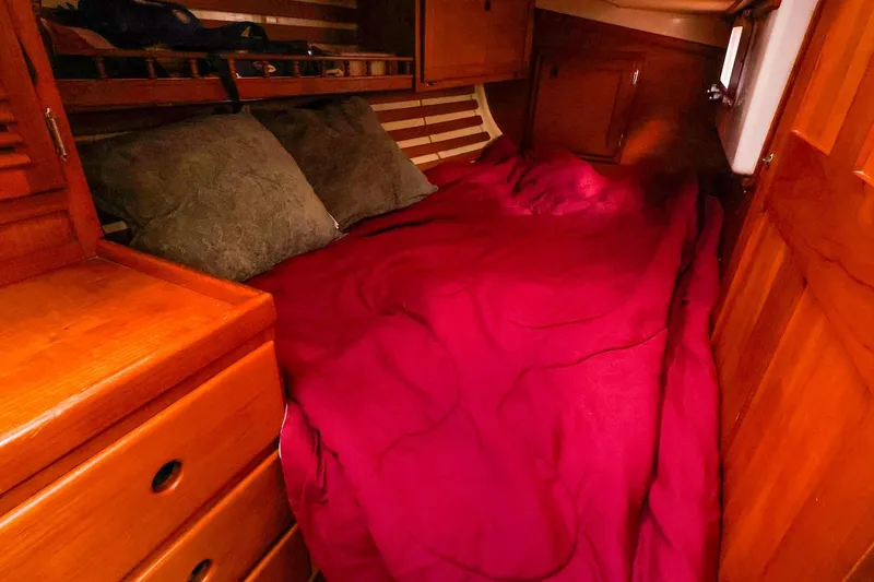 Slide: The Image of Cozy cabin interior of 1985 Bayfield 40 yacht with red bedding and wooden furnishings. - 24