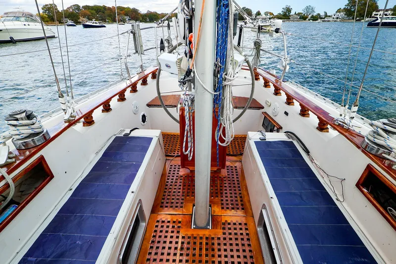 Slide: The Image of Cockpit of 1985 Bayfield 40 yacht with blue seating and wooden flooring. - 5