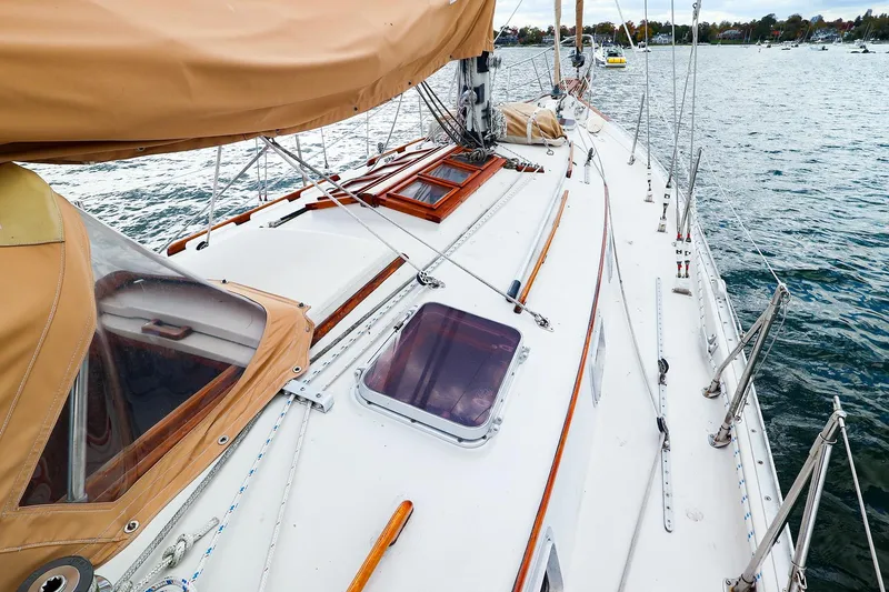 Slide: The Image of 1985 Bayfield 40 yacht deck with tan covers, sailing on calm waters. - 6