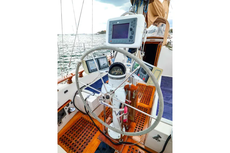 Slide: The Image of 1985 Bayfield 40 yacht cockpit with steering wheel and navigation equipment. - 8