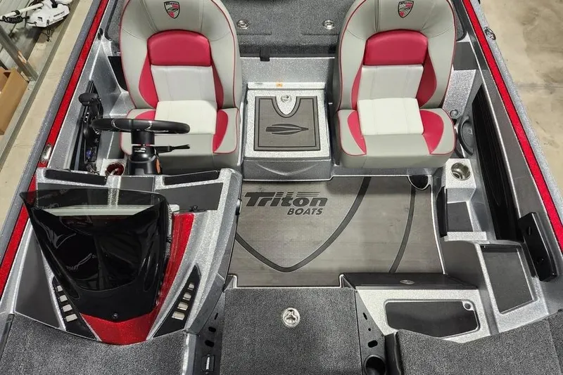 Slide: The Image of 2026 Triton 20XP Patriot boat interior with red and gray seating, steering console, and branding. - 10