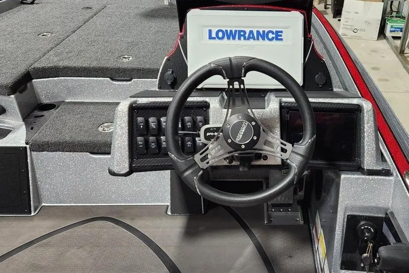 Slide: The Image of 2026 Triton 20XP Patriot boat dashboard with Lowrance display and steering wheel. - 5