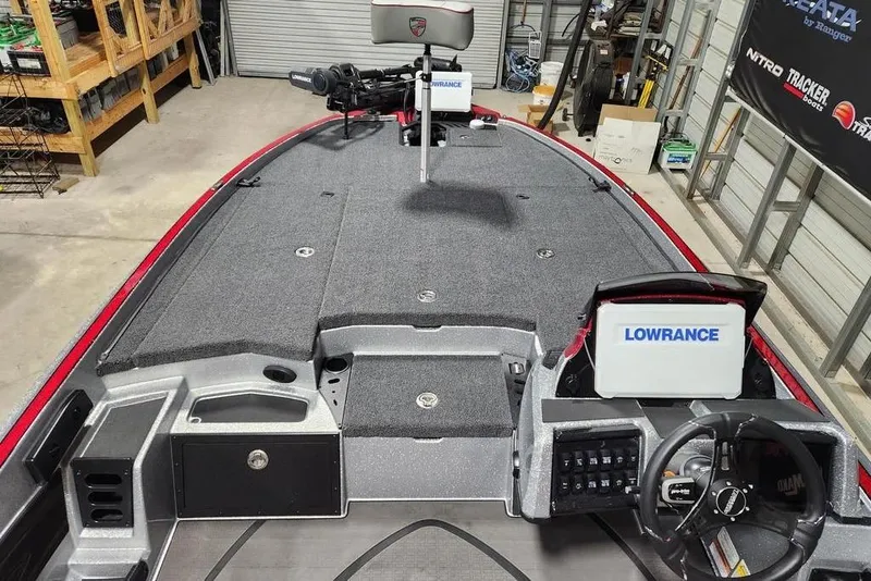 Slide: The Image of 2026 Triton 20XP Patriot boat interior with Lowrance electronics in a garage setting. - 8