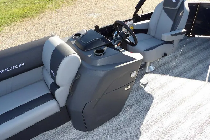 Slide: The Image of 2026 Bennington S L-Bench 22 SL boat interior with gray seating and steering console. - 11