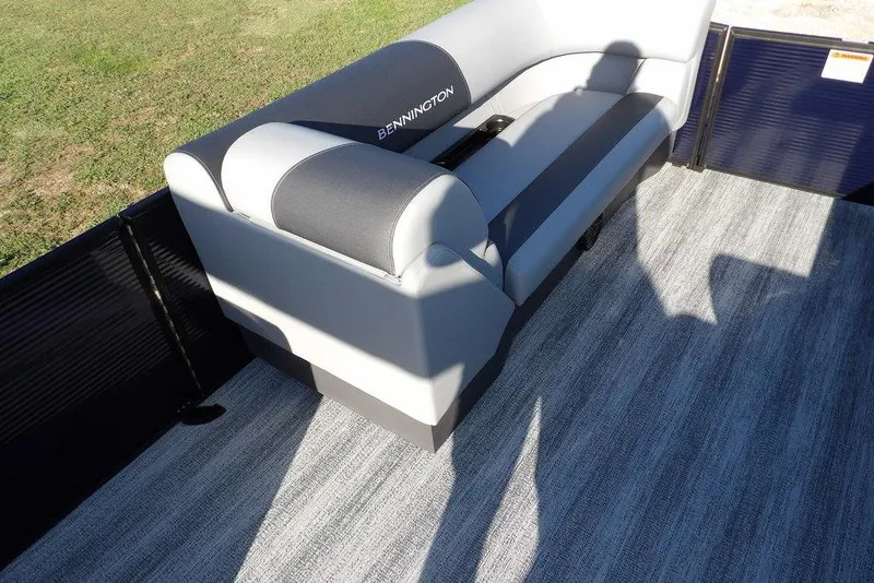 Slide: The Image of 2026 Bennington S L-Bench 22 SL boat interior with gray seating and carpet. - 14