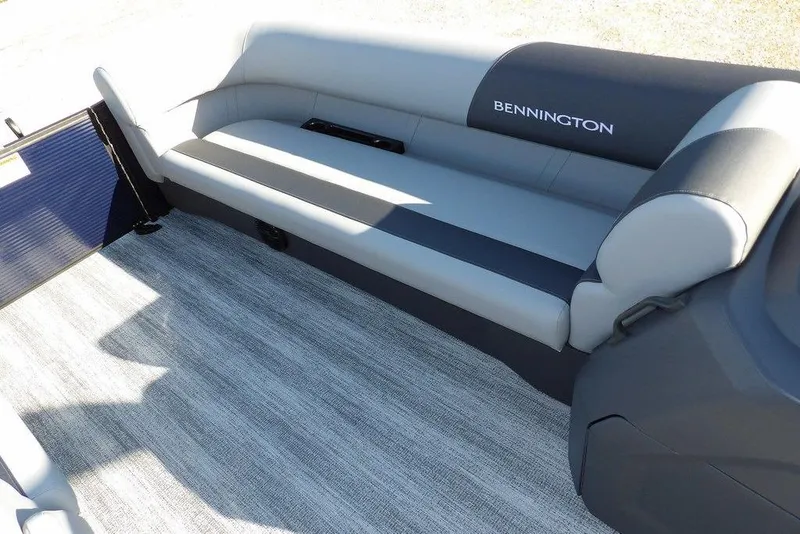 Slide: The Image of 2026 Bennington S L-Bench 22 SL boat interior with gray seating and carpet flooring. - 17