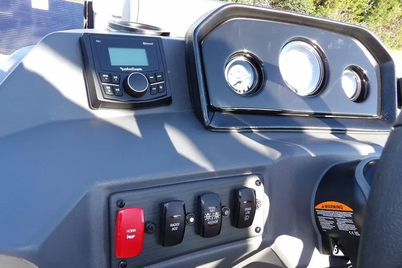 Slide: The Image of 2026 Bennington S L-Bench 22 SL dashboard with controls and gauges. - 21