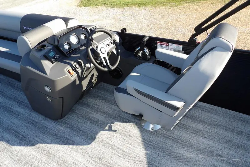 Slide: The Image of 2026 Bennington S L-Bench 22 SL boat interior with steering console and captain's chair. - 22