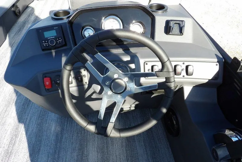 Slide: The Image of 2026 Bennington S L-Bench 22 SL boat dashboard with steering wheel and controls. - 23