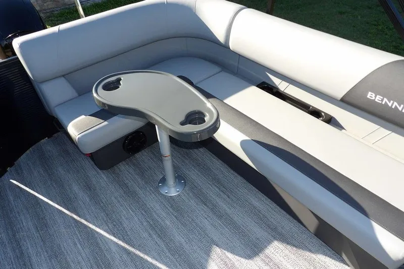 Slide: The Image of 2026 Bennington S L-Bench 22 SL boat interior with gray seating and table. - 26