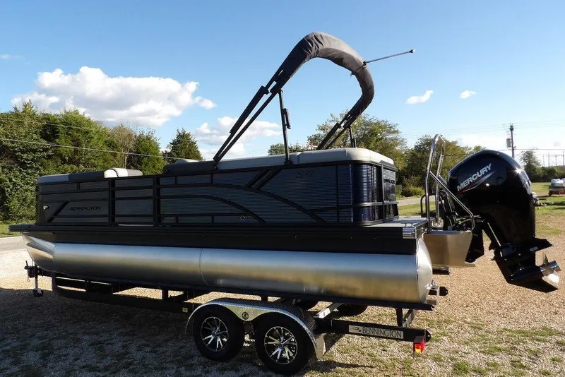 Slide: The Image of 2026 Bennington S L-Bench 22 SL pontoon boat on trailer, sunny day. - 4