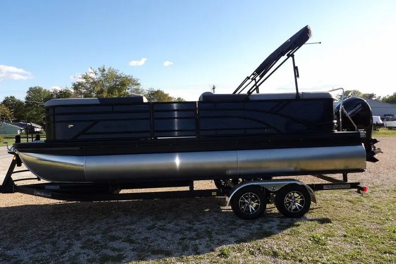 Slide: The Image of 2026 Bennington S L-Bench 22 SL pontoon boat on trailer, parked outdoors. - 6