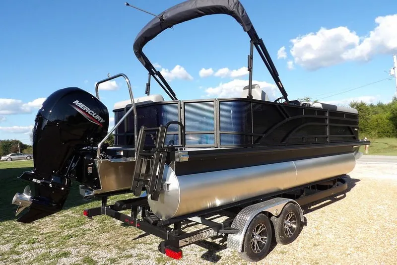 Slide: The Image of 2026 Bennington S L-Bench 22 SL pontoon boat with Mercury outboard engine on trailer. - 9