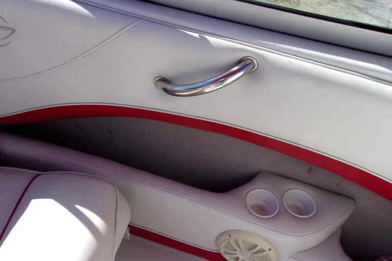 Slide: The Image of Interior of 2002 Crownline 202 BR boat with white and red upholstery, cup holders, and speaker. - 13