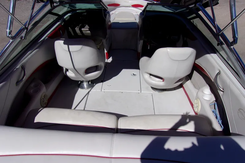 Slide: The Image of Interior of 2002 Crownline 202 BR boat with white seating and steering area. - 4