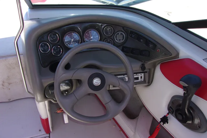 Slide: The Image of 2002 Crownline 202 BR boat dashboard with steering wheel and control panel. - 5