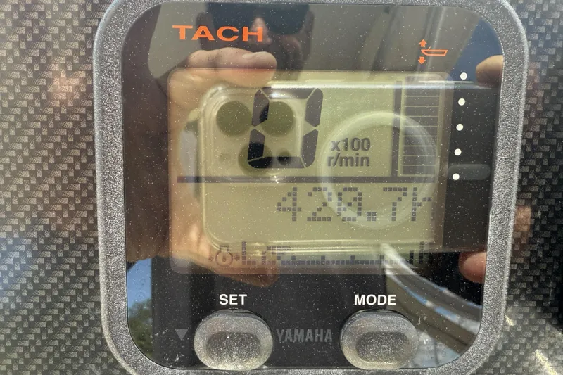 Slide: The Image of Tachometer display on 2014 Grady-White Freedom 275 boat, showing 420.7 hours. - 12