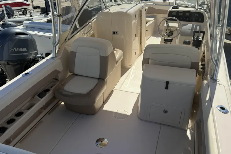 Slide: The Image of 2014 Grady-White Freedom 275 boat interior with seating and Yamaha engine. - 20