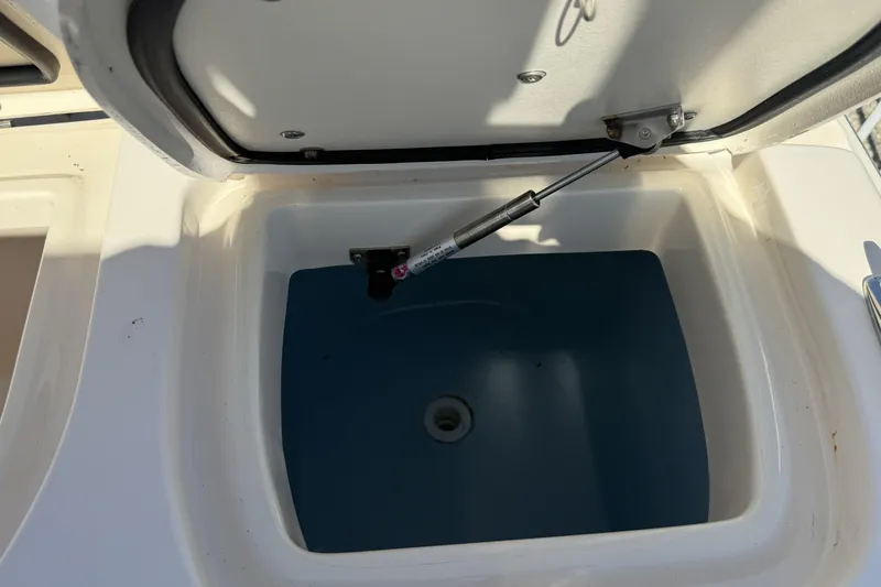 Slide: The Image of Open storage compartment on 2014 Grady-White Freedom 275 boat, showing interior details. - 23