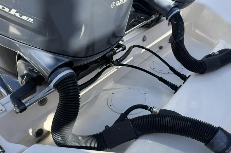 Slide: The Image of 2014 Grady-White Freedom 275 boat with Yamaha outboard engines and hoses. - 25