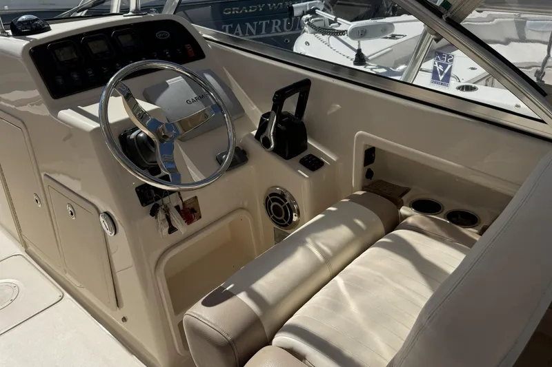 Slide: The Image of 2014 Grady-White Freedom 275 boat cockpit with steering wheel and control panel. - 29