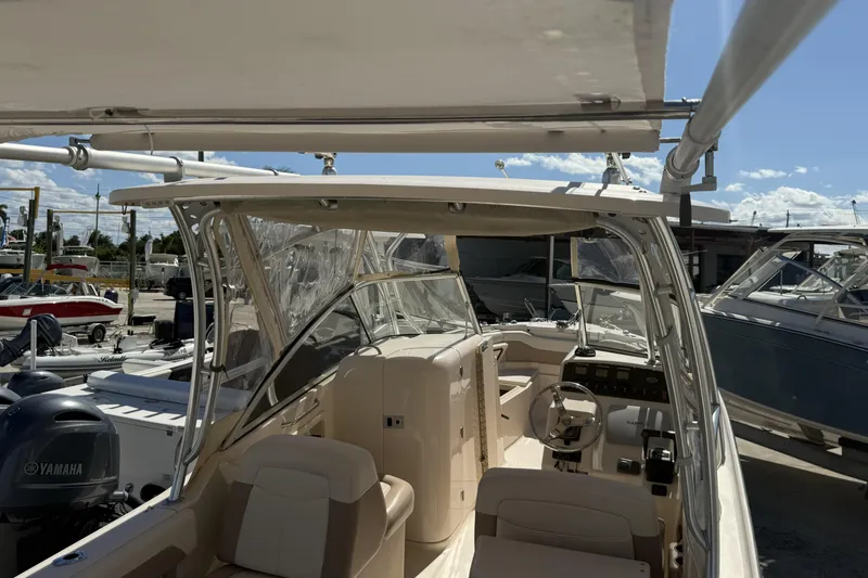 Slide: The Image of 2014 Grady-White Freedom 275 boat interior with seating and steering console. - 31