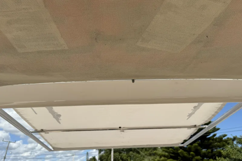 Slide: The Image of 2014 Grady-White Freedom 275 boat canopy under clear blue sky. - 33