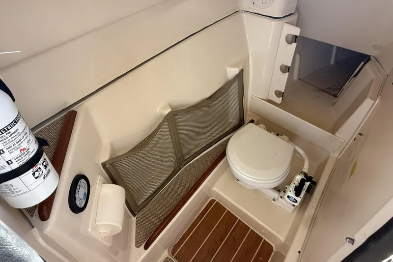 Slide: The Image of 2014 Grady-White Freedom 275 boat interior with toilet and fire extinguisher. - 41