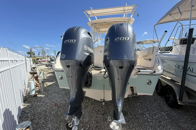 Slide: The Image of 2014 Grady-White Freedom 275 boat with twin Yamaha 200 engines, docked outdoors. - 42