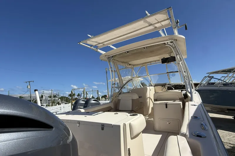 Slide: The Image of 2014 Grady-White Freedom 275 boat with dual Yamaha engines under clear blue sky. - 44