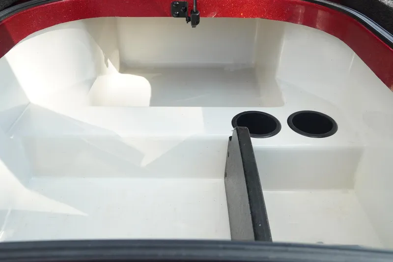 Slide: The Image of 2011 Ranger Z119 boat storage compartment with cup holders and red trim. - 18