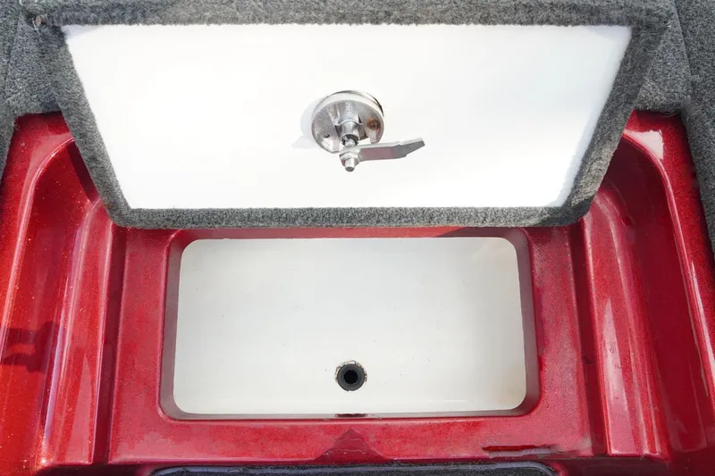 Slide: The Image of 2011 Ranger Z119 boat compartment with red trim and latch. - 19