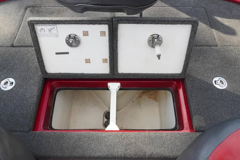 Slide: The Image of 2011 Ranger Z119 boat storage compartments with pump-out valve controls. - 25