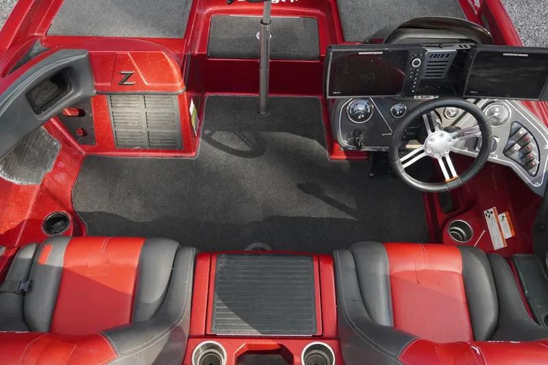 Slide: The Image of Red 2011 Ranger Z119 boat interior with steering wheel and dual screens. - 4