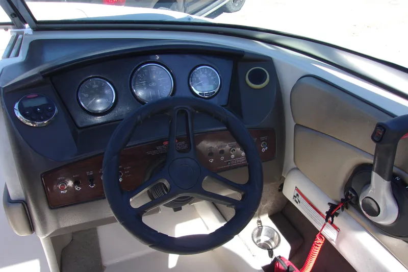 Slide: The Image of 2007 Sea Ray 210 Select boat dashboard with steering wheel and control panel. - 5