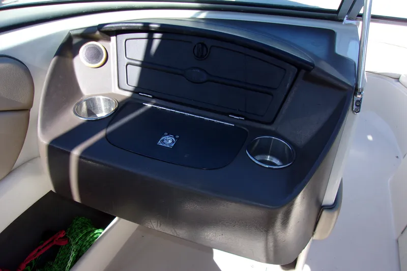 Slide: The Image of 2007 Sea Ray 210 Select boat dashboard with cup holders and storage compartment. - 6