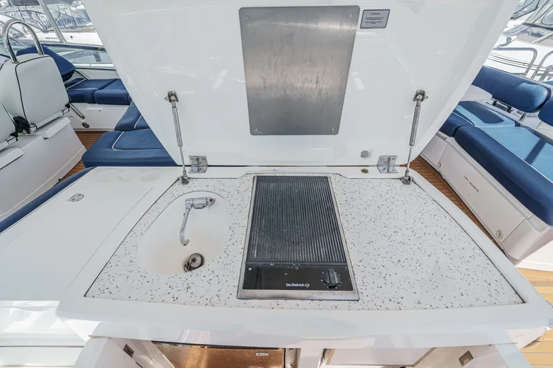 Slide: The Image of Outdoor kitchen area on 2006 Fairline 74 Custom yacht with sink and grill. - 11