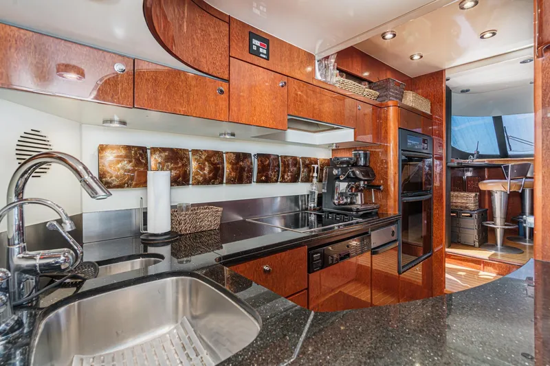 Slide: The Image of Luxurious kitchen interior of 2006 Fairline 74 Custom yacht with modern appliances and wood finish. - 18