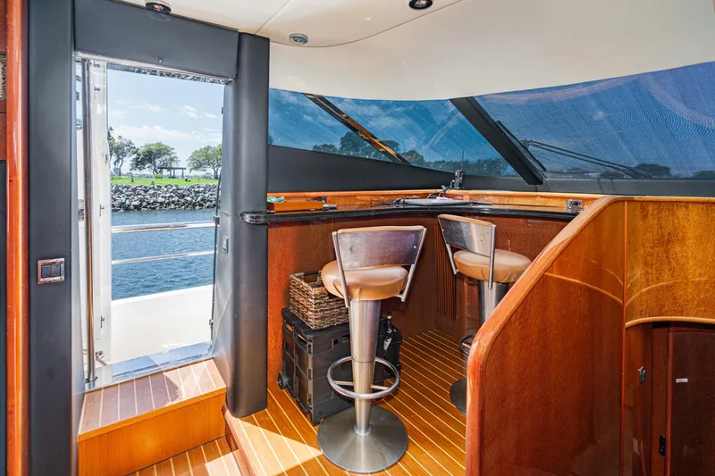 Slide: The Image of Luxurious interior of 2006 Fairline 74 Custom yacht with bar seating and scenic view. - 22