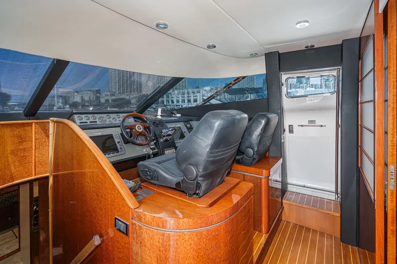 Slide: The Image of Interior helm of 2006 Fairline 74 Custom yacht with leather seats and wood finish. - 24