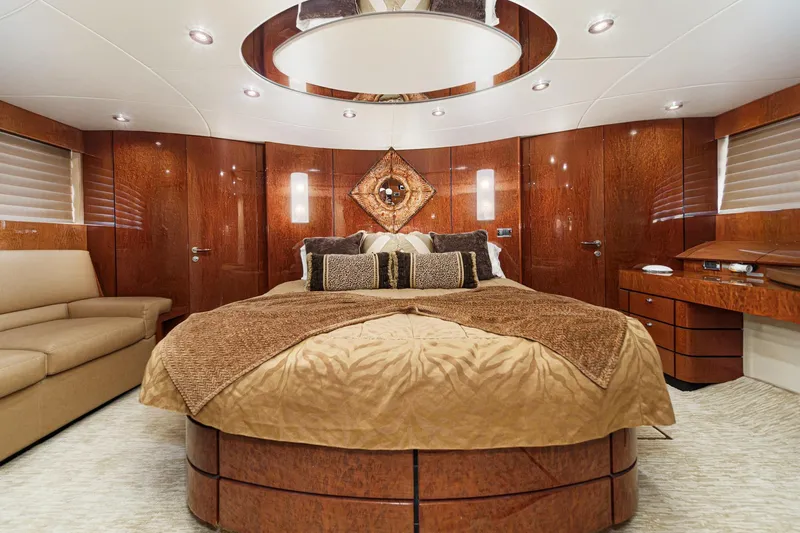 Slide: The Image of Luxurious 2006 Fairline 74 Custom yacht bedroom with elegant wood paneling and plush bedding. - 27