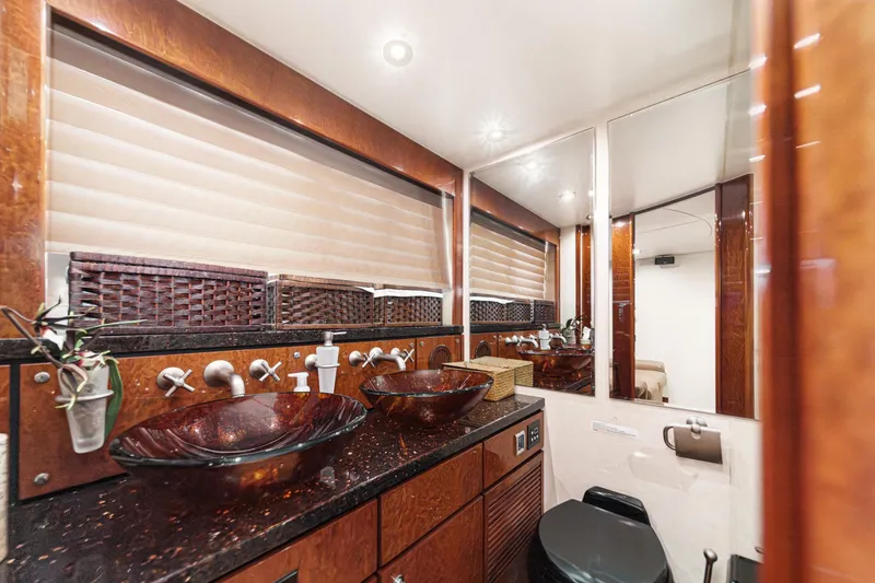 Slide: The Image of Luxurious bathroom in 2006 Fairline 74 Custom yacht with elegant glass sinks and wood accents. - 30