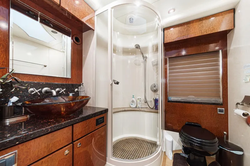 Slide: The Image of Luxurious bathroom in 2006 Fairline 74 Custom yacht with modern fixtures and elegant wood finishes. - 36